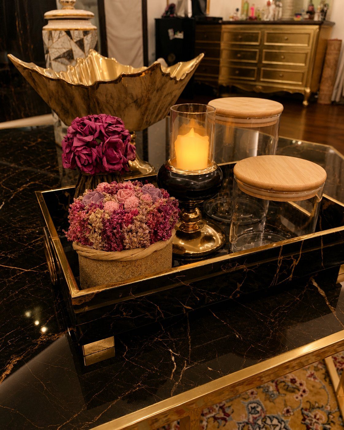 Black marble coffee table styling with dried florals and brass candle holder