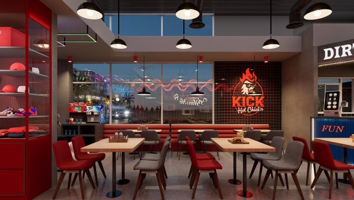 Dining hall with the flaming-rooster Kick Hot Chick'n neon brand wall