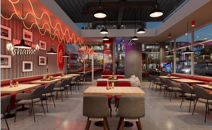 Dining area with neon signage and a framed photo wall