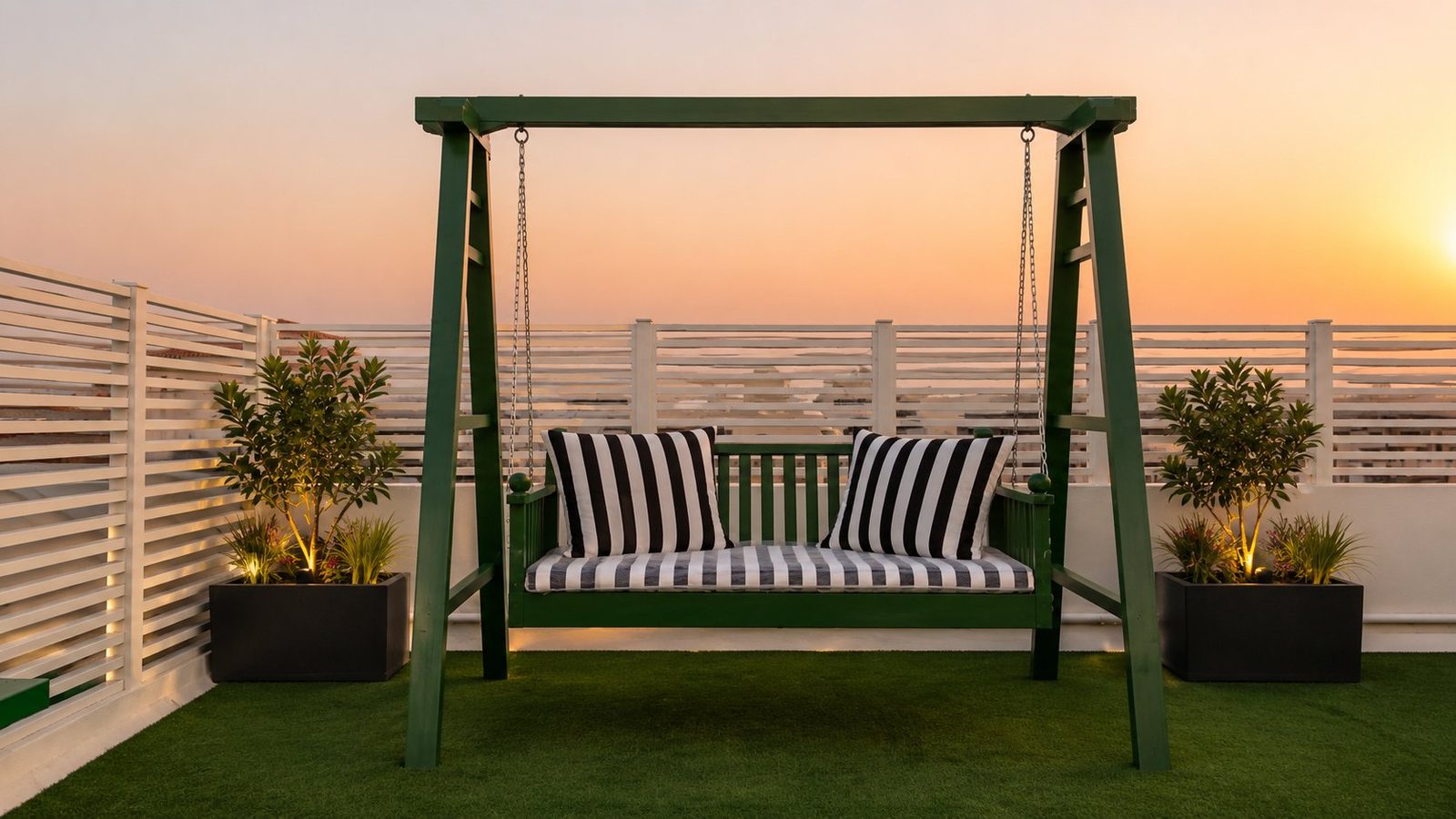 Green outdoor swing on rooftop deck at sunset
