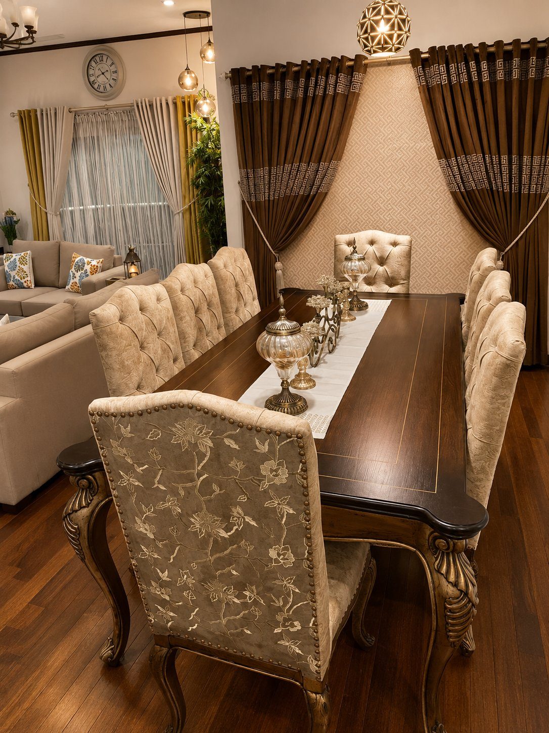 Long dining table set with brass candelabra and embroidered chairs