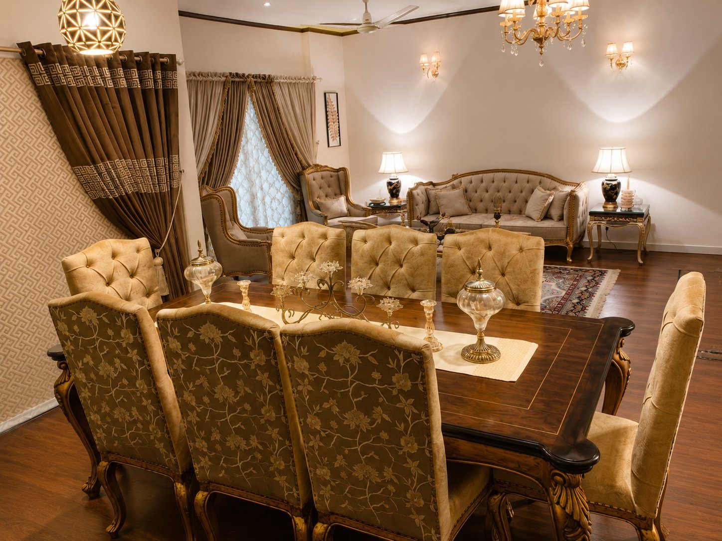 Dining room view through to gold drawing room with tufted sofas