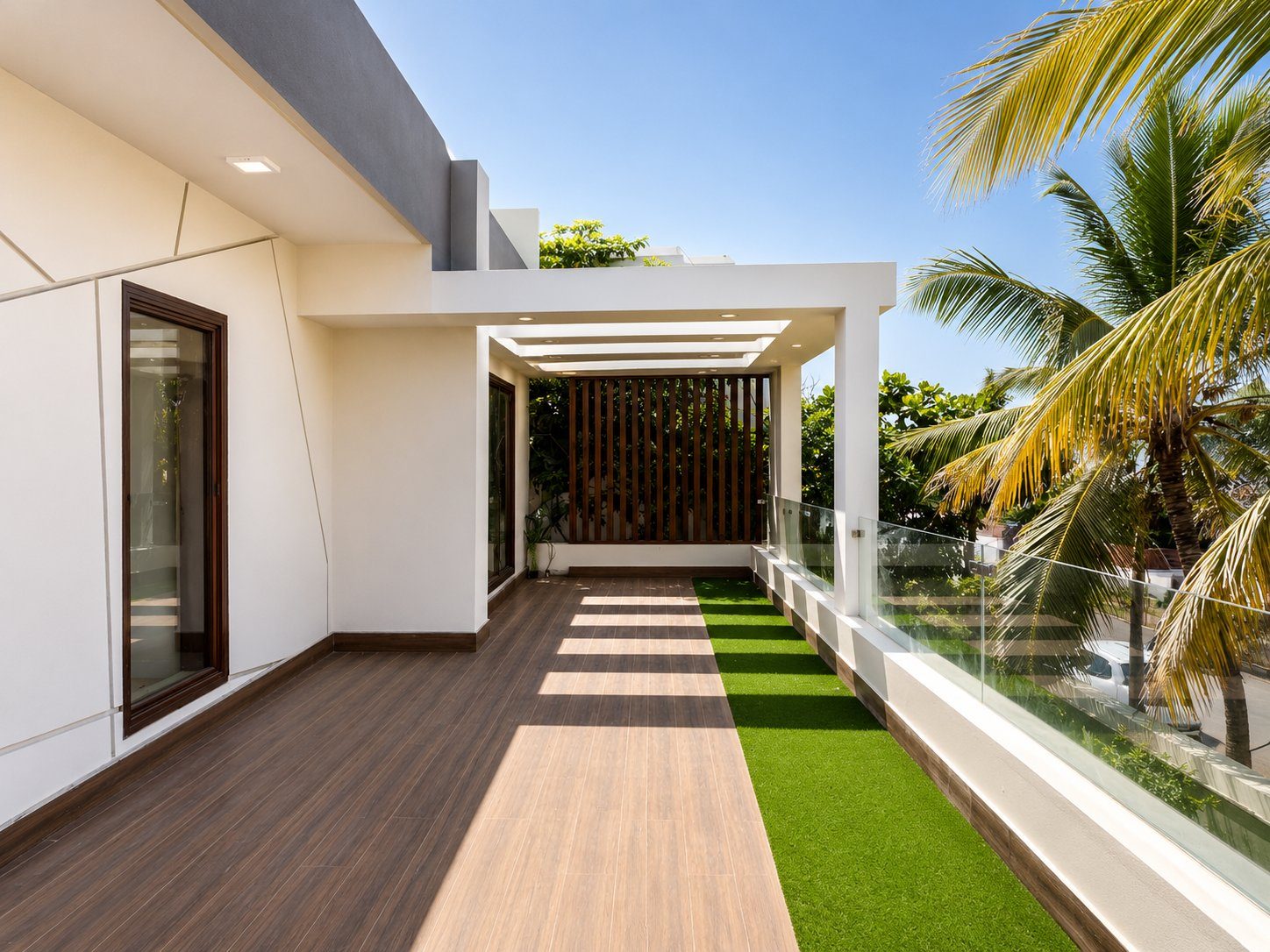 Exterior facade of the residence with palm tree and rooftop pergola
